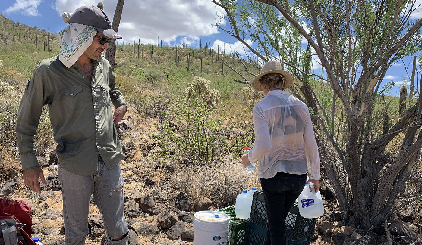 Scott Warren and Emily Saunders leave water in the Arizona desert. Photo Credit: Jude Joffe-Block