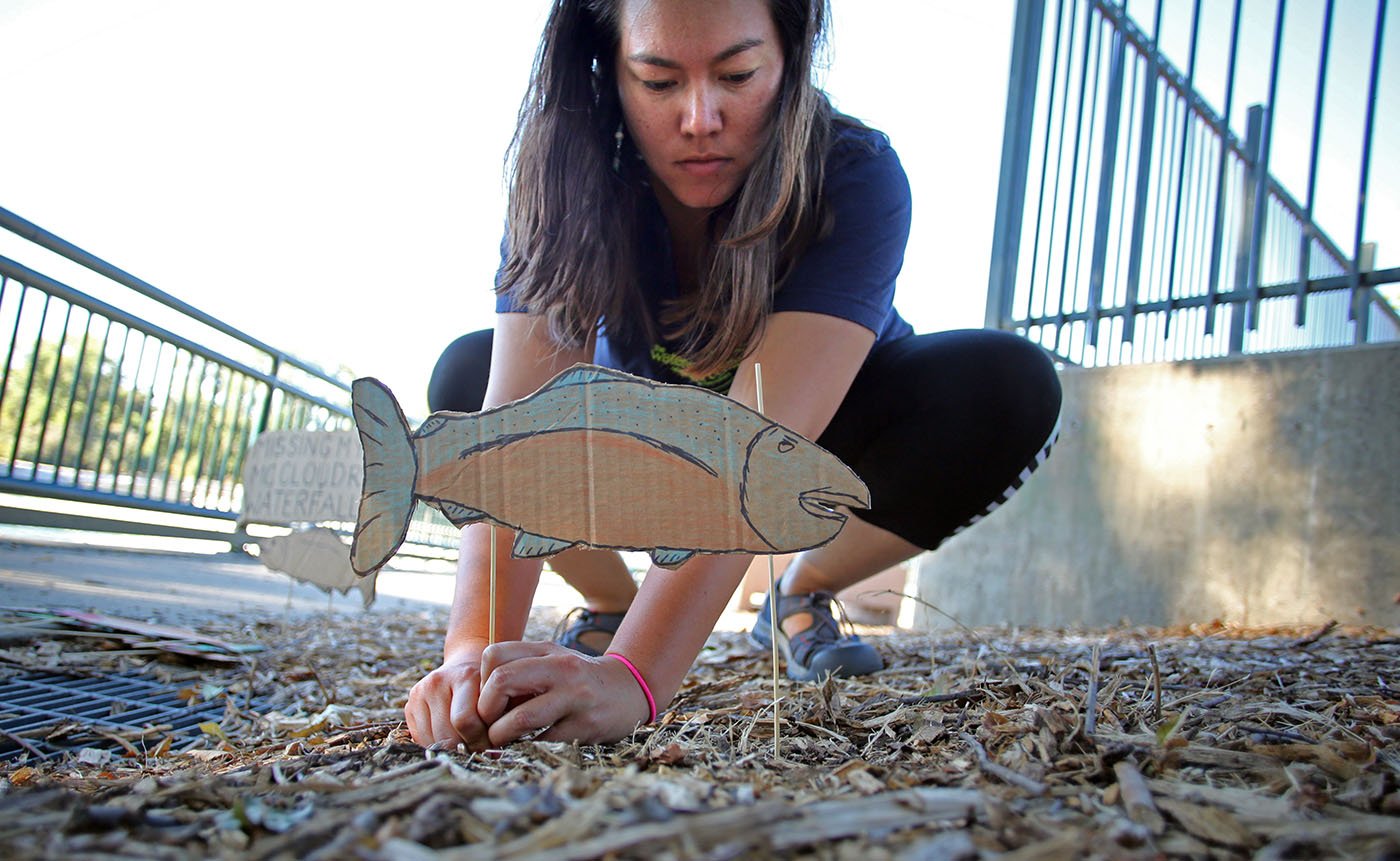 Redding, CA — Rebekah Olstad places a sign to call attention to the negative impacts of dams on Chinook salmon. September 25, 2019. Tom Levy/The Spiritual Edge