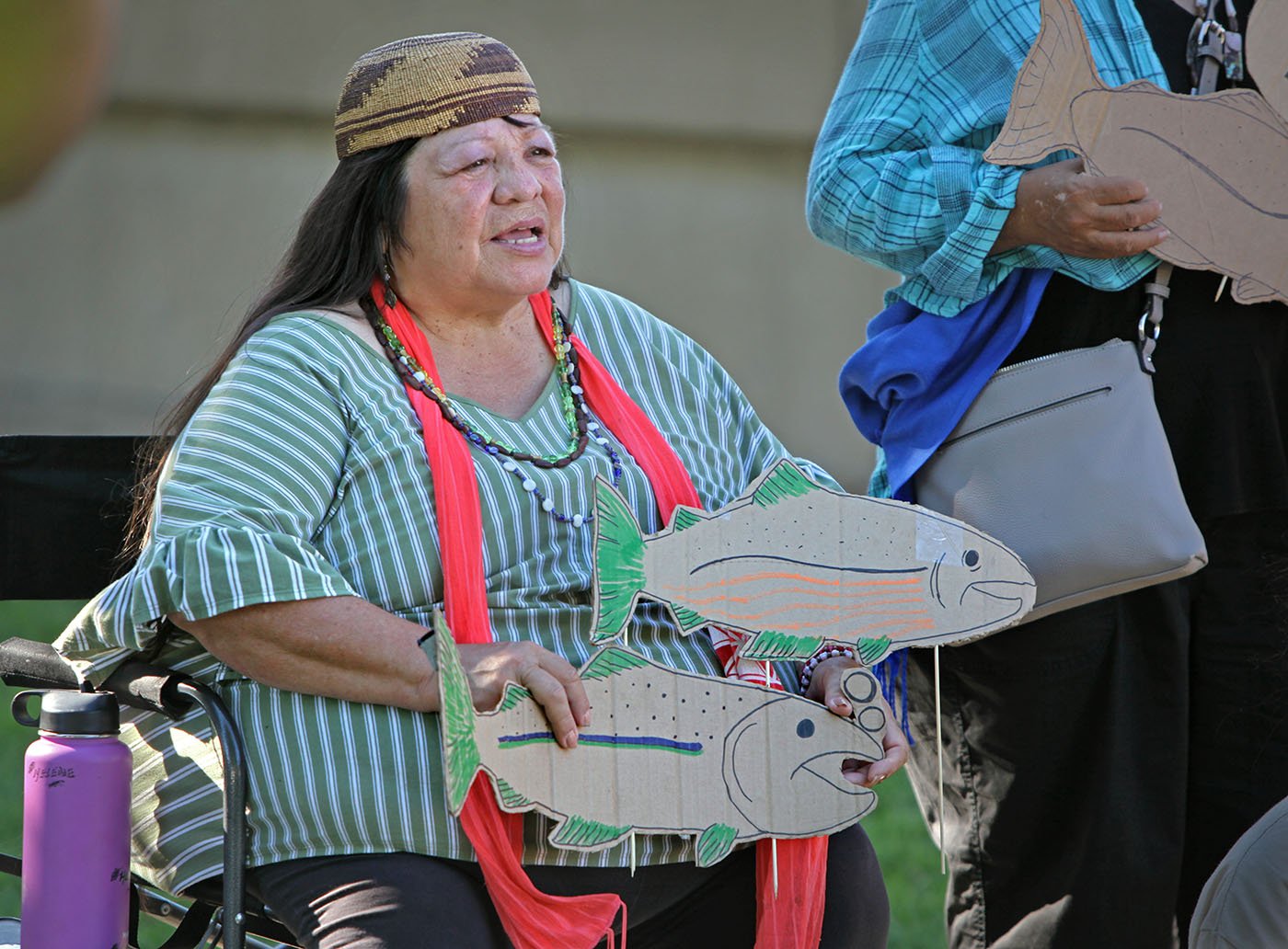 Shasta Lake, CA — Winnemem Wintu song leader Helene Sisk joins a protest outside the Shasta Dam Visitor Center. September 25, 2019. Tom Levy/The Spiritual Edge