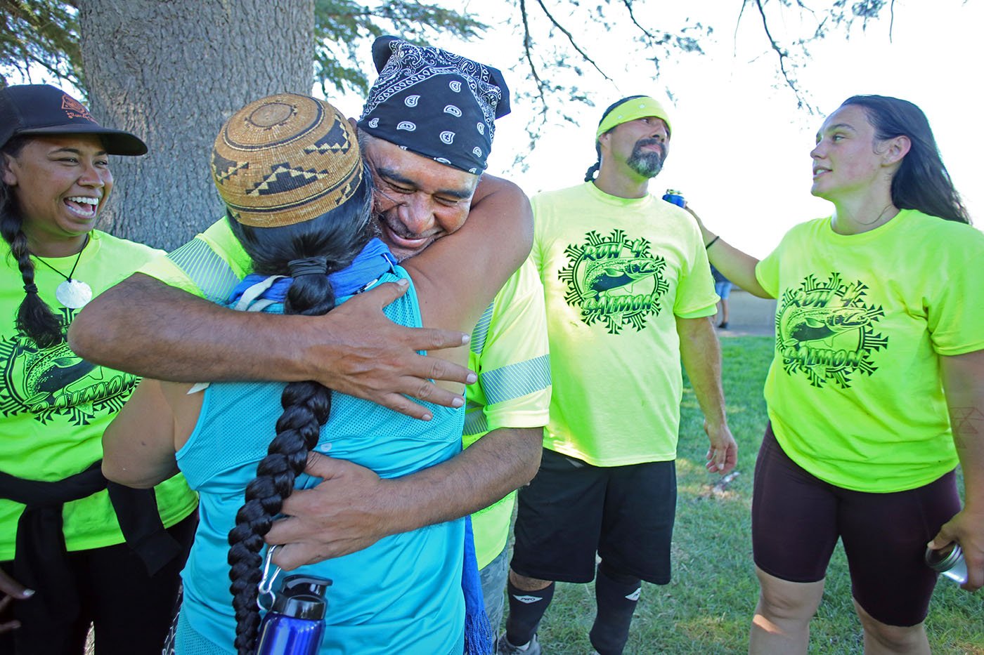 Shasta Lake, CA — After the runners arrive, a happy Chief Caleen Sisk hugs Gary Thomas, an Elem Pomo ceremonial song leader from Lake County. September 25, 2019. Tom Levy/The Spiritual Edge