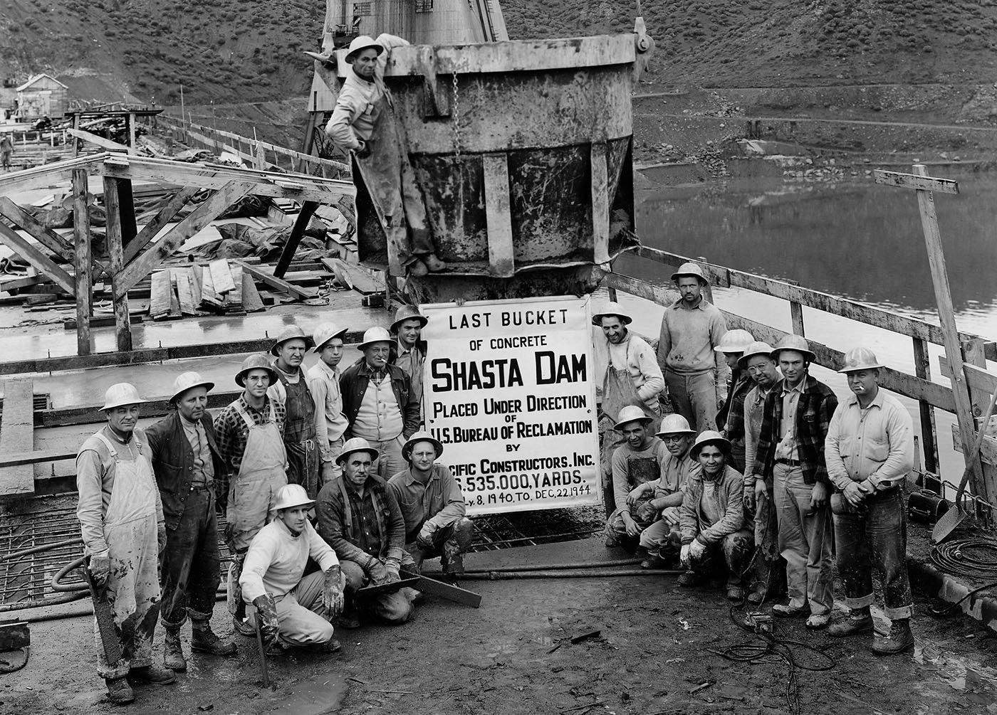 Shasta County — Crew of Pacific Constructors, Inc. grouped around the last bucket of concrete spilled for Shasta Dam on Dec. 22, 1944. U.S. Bureau of Reclamation, Central Valley Project History